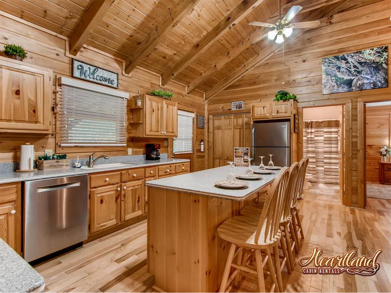 Open kitchen with appliances and seating for 4 people